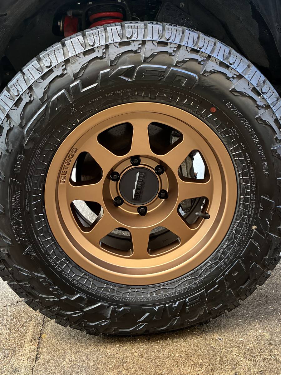 The same bronze wheel cleaned, with black tire and clean wheel well after a Drip-N-Shine wash
