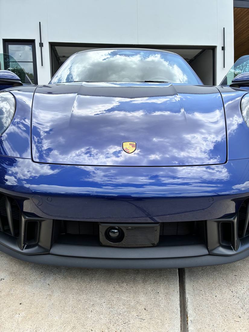 Blue Porsche 911 washed and gleaming in a Hill Country driveway
